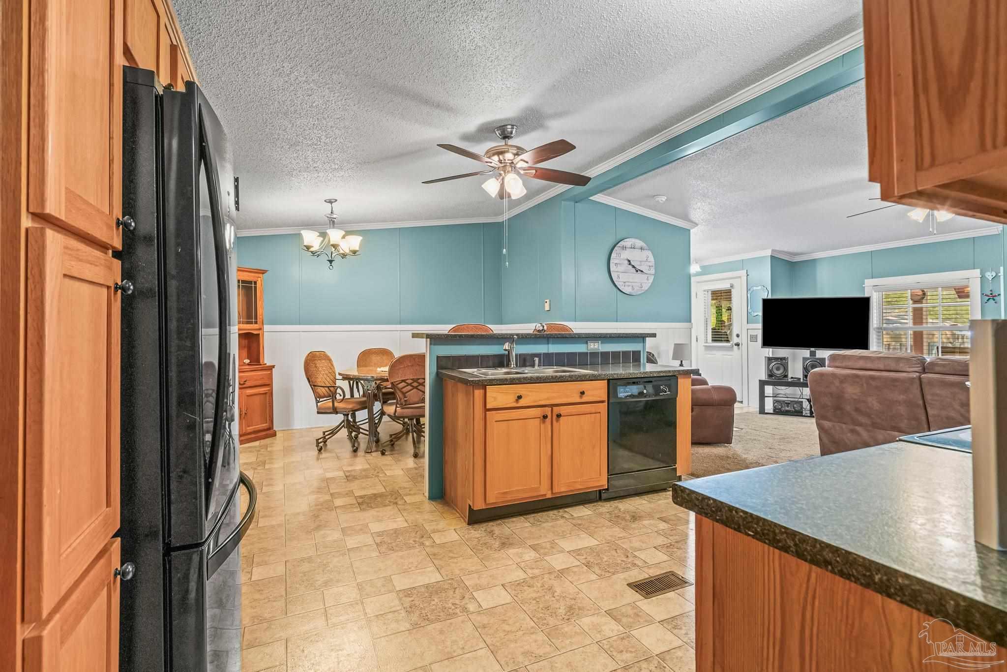 5105 April Lane Pace, FL 32571 - Photo 19 of 57 a kitchen with stainless steel appliances granite countertop a stove top oven a sink a dining table and chairs