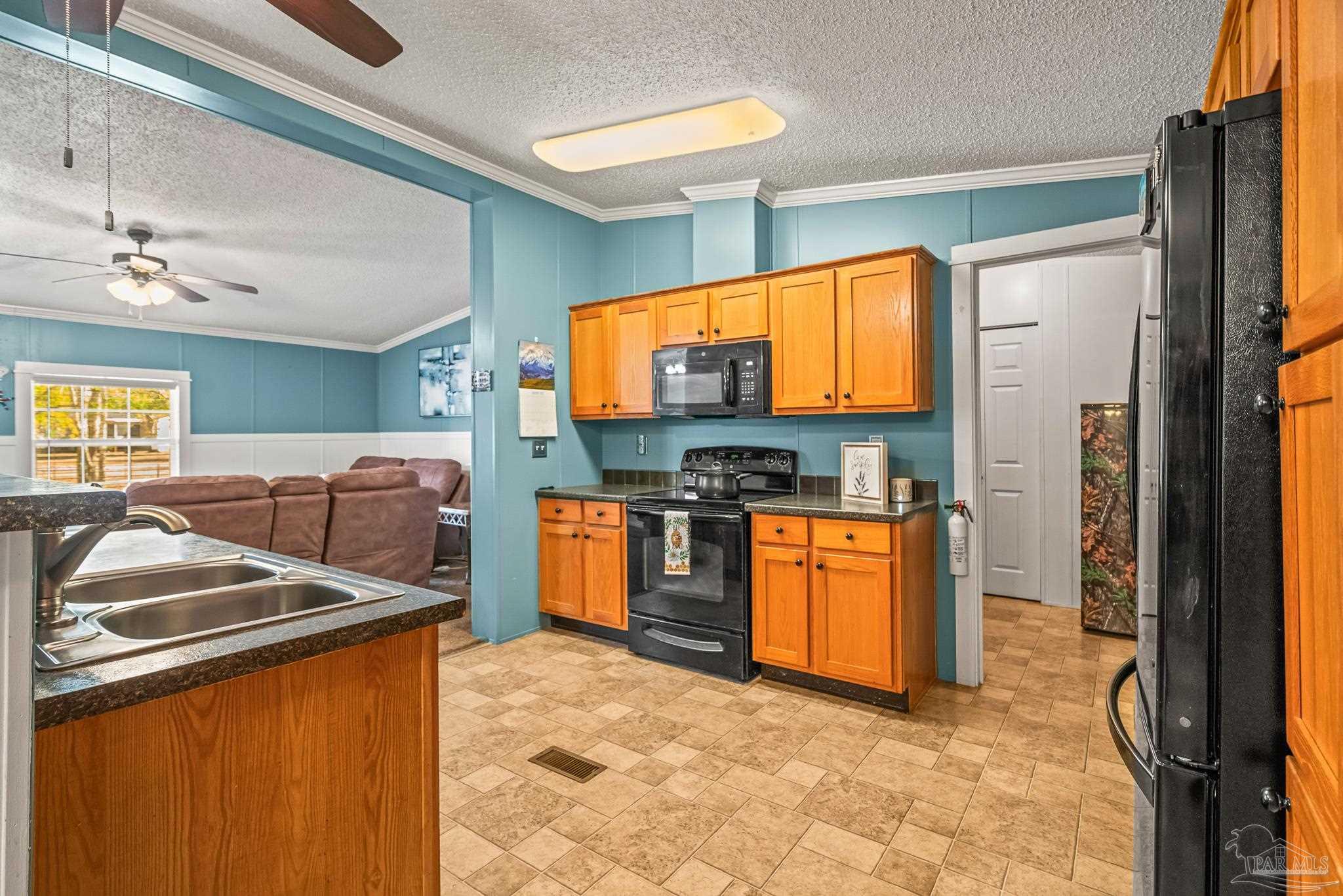 5105 April Lane Pace, FL 32571 - Photo 20 of 57 a kitchen with stainless steel appliances granite countertop a stove a sink and a refrigerator