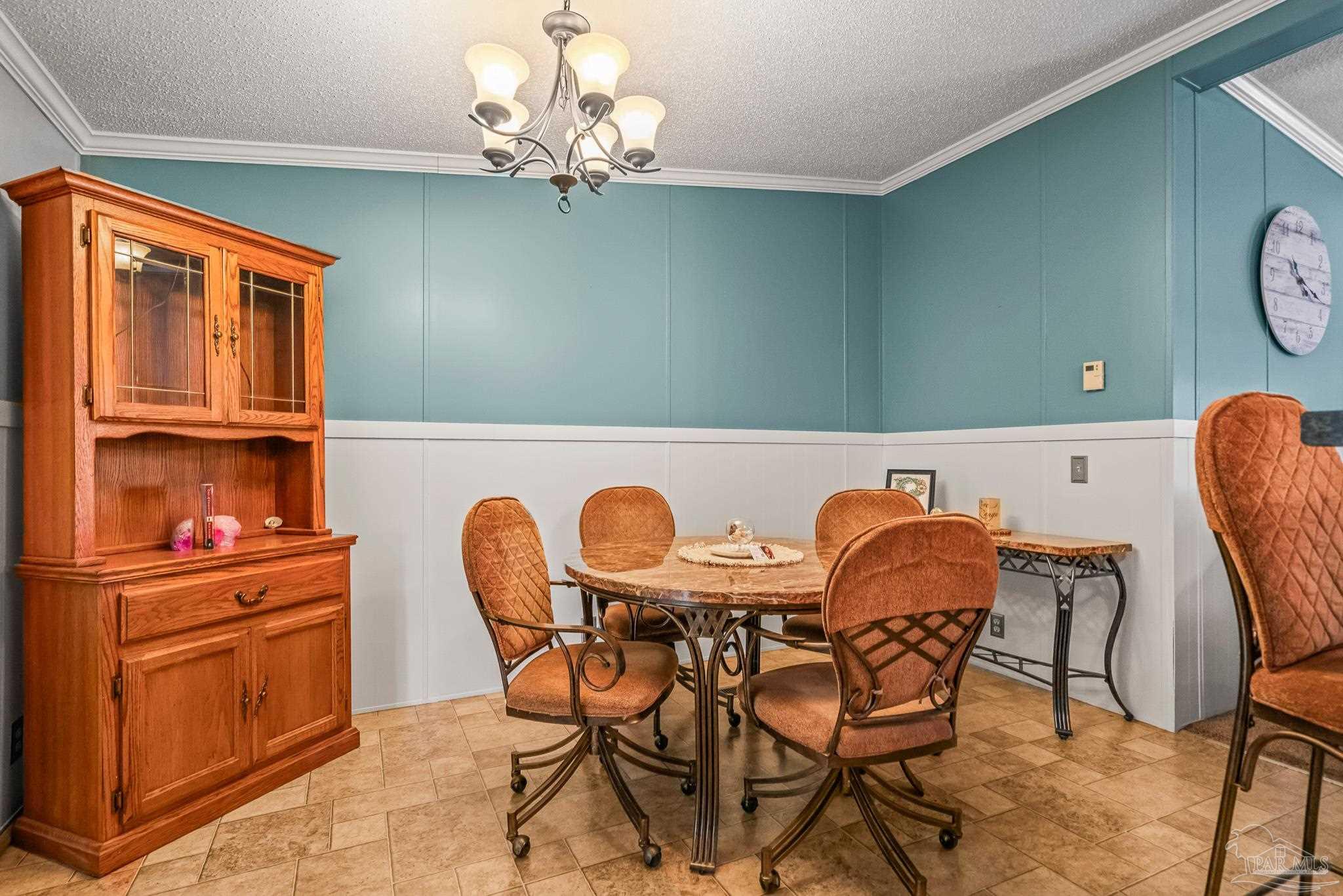 5105 April Lane Pace, FL 32571 - Photo 21 of 57 a view of a dining room with furniture and chandelier