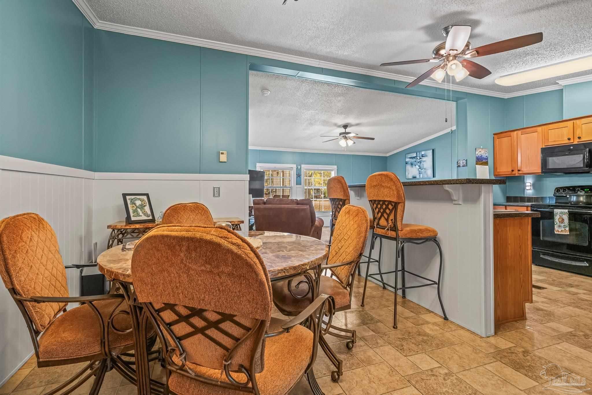 5105 April Lane Pace, FL 32571 - Photo 23 of 57 a dining room filled chandelier and wooden floor