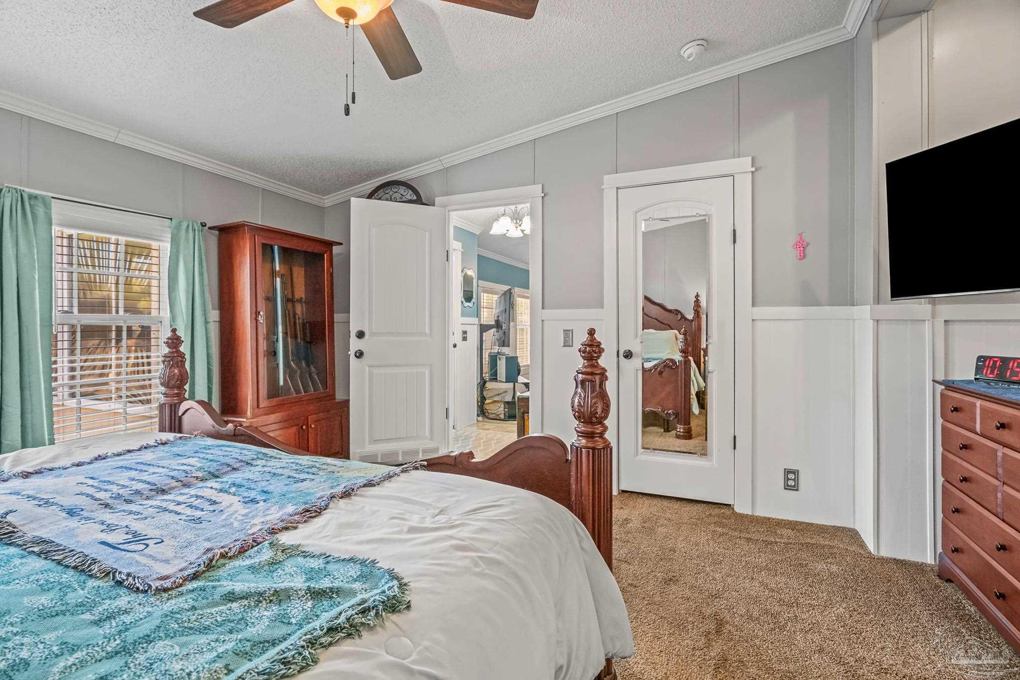 5105 April Lane Pace, FL 32571 - Photo 28 of 57 a bedroom with a bed and a flat screen tv