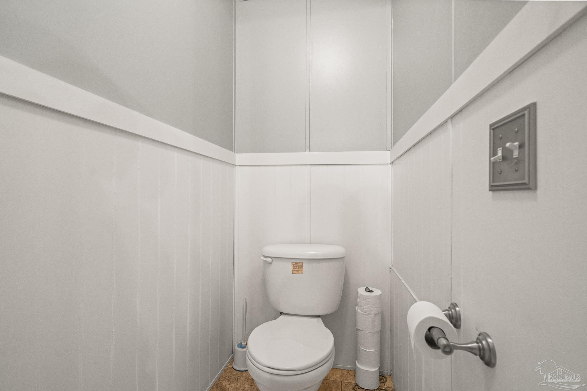 5105 April Lane Pace, FL 32571 - Photo 32 of 57 a white toilet sitting next to a shower