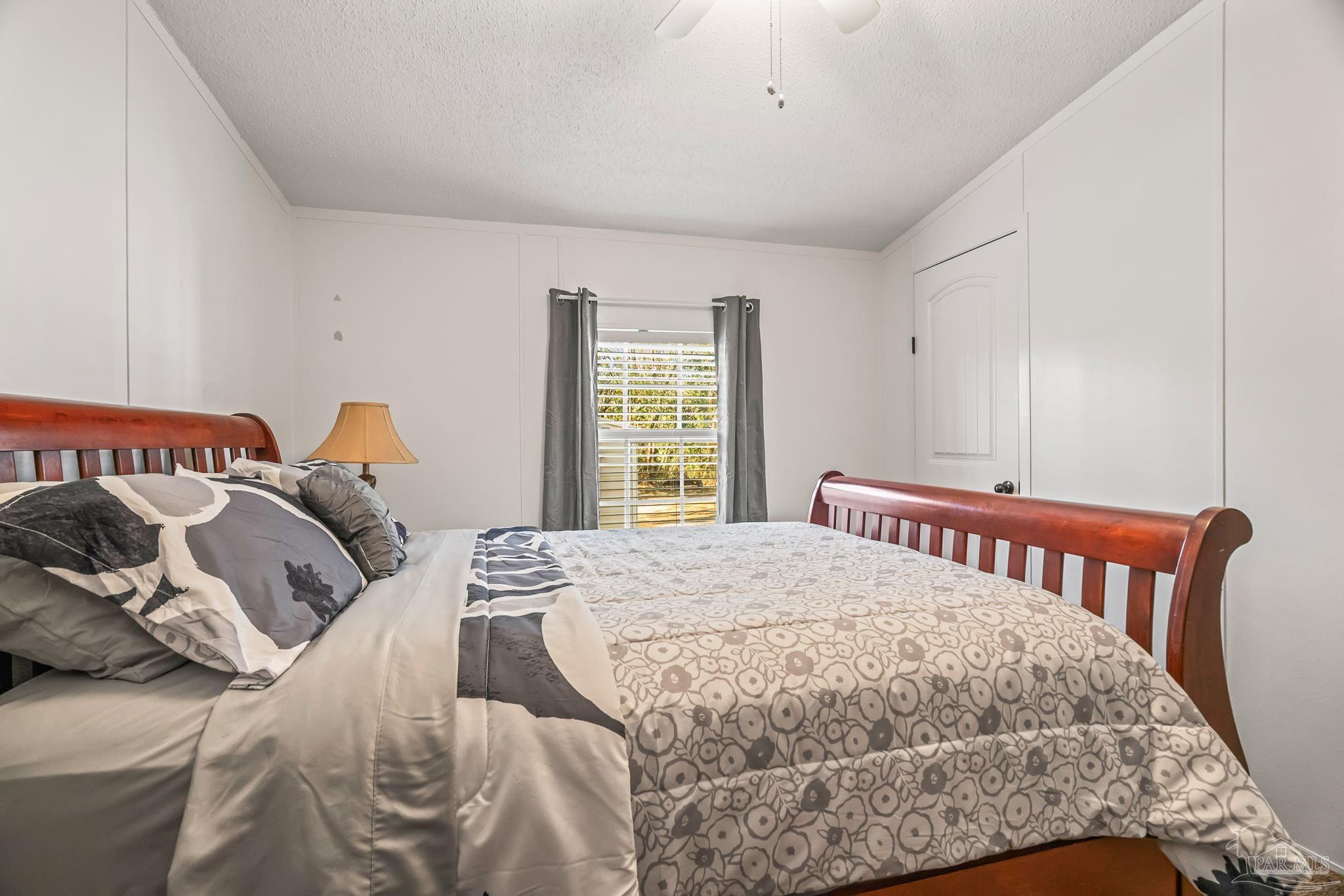 5105 April Lane Pace, FL 32571 - Photo 42 of 57 a bedroom with a bed and a window
