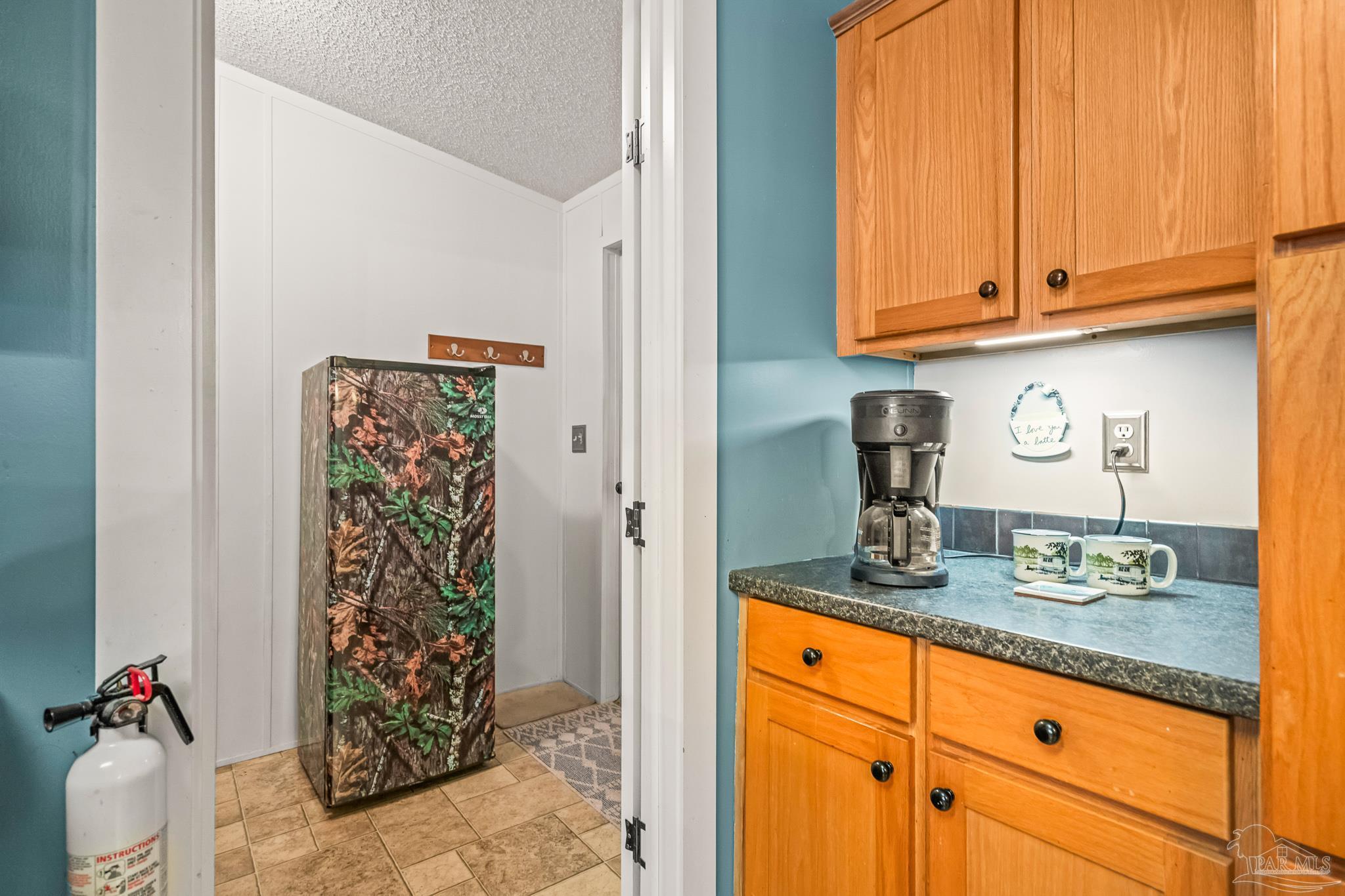 5105 April Lane Pace, FL 32571 - Photo 46 of 57 a kitchen with stainless steel appliances granite countertop a refrigerator and a stove top oven