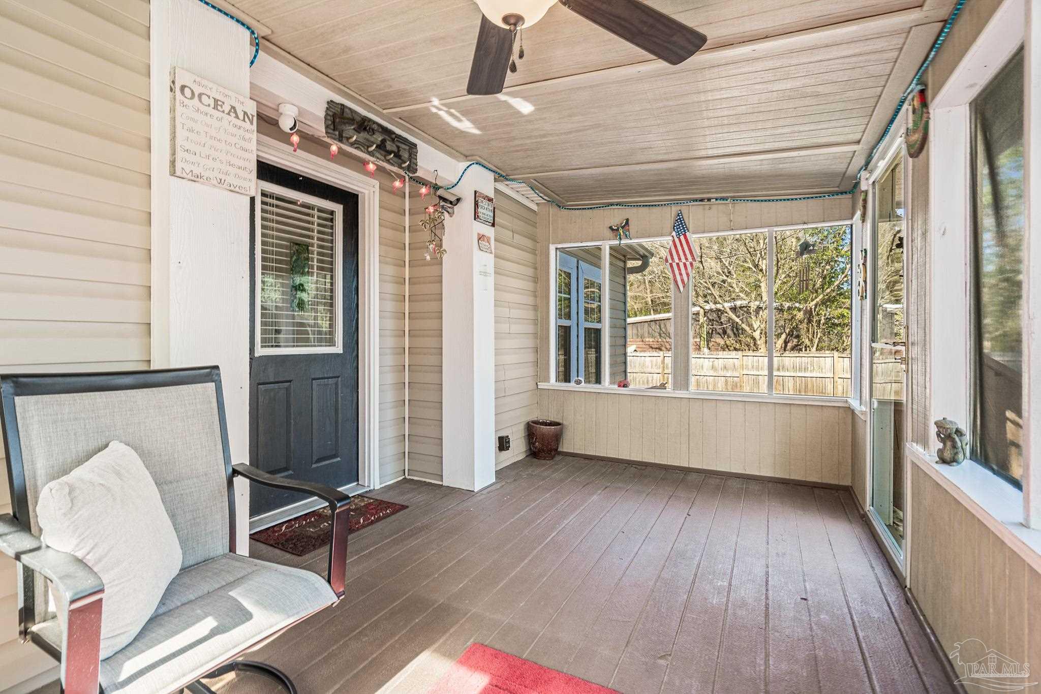 5105 April Lane Pace, FL 32571 - Photo 5 of 57 a view of an empty room with wooden floor and a window