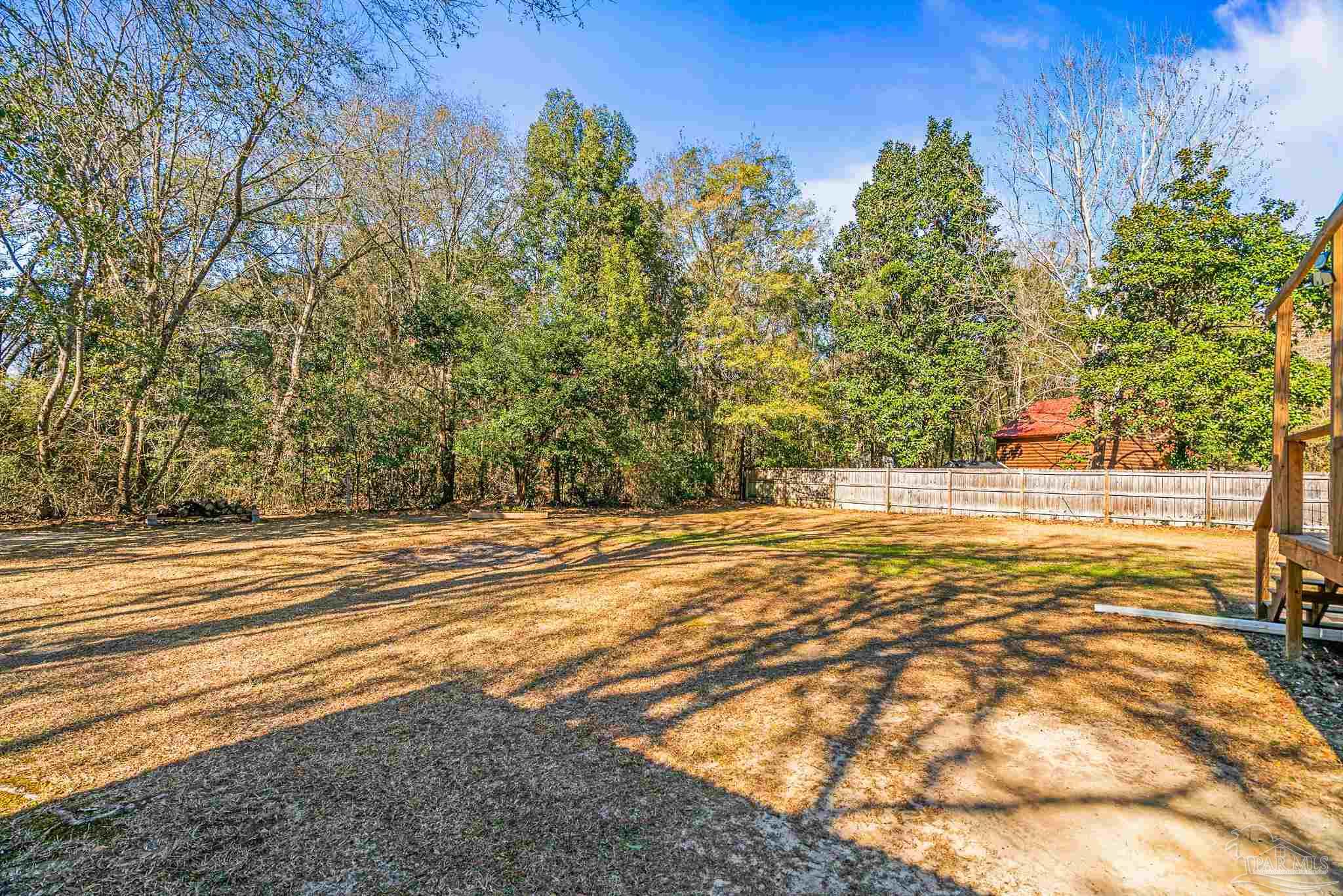 5105 April Lane Pace, FL 32571 - Photo 55 of 57 a view of a yard with trees