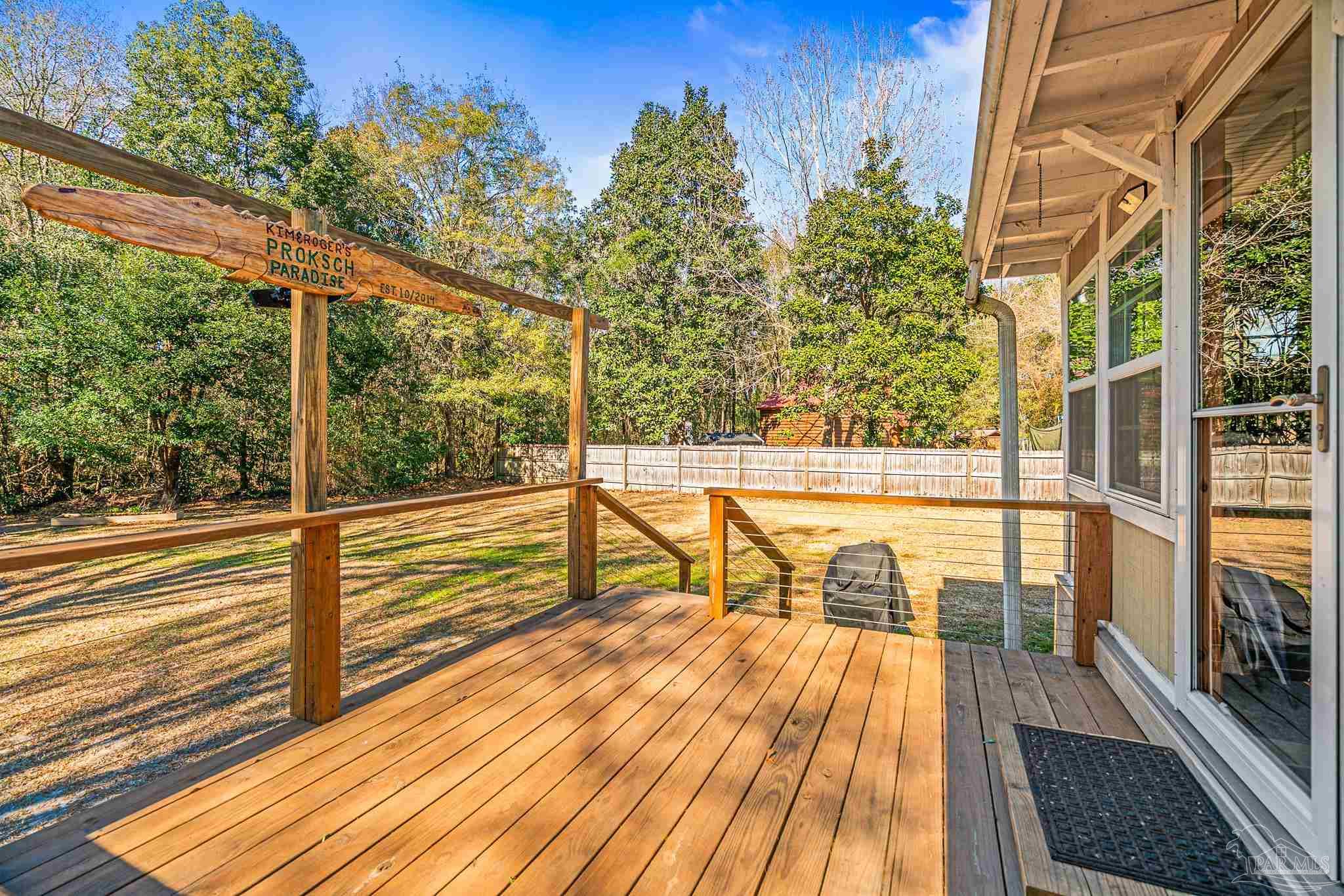 5105 April Lane Pace, FL 32571 - Photo 8 of 57 a view of a balcony with floor to ceiling windows with wooden floor