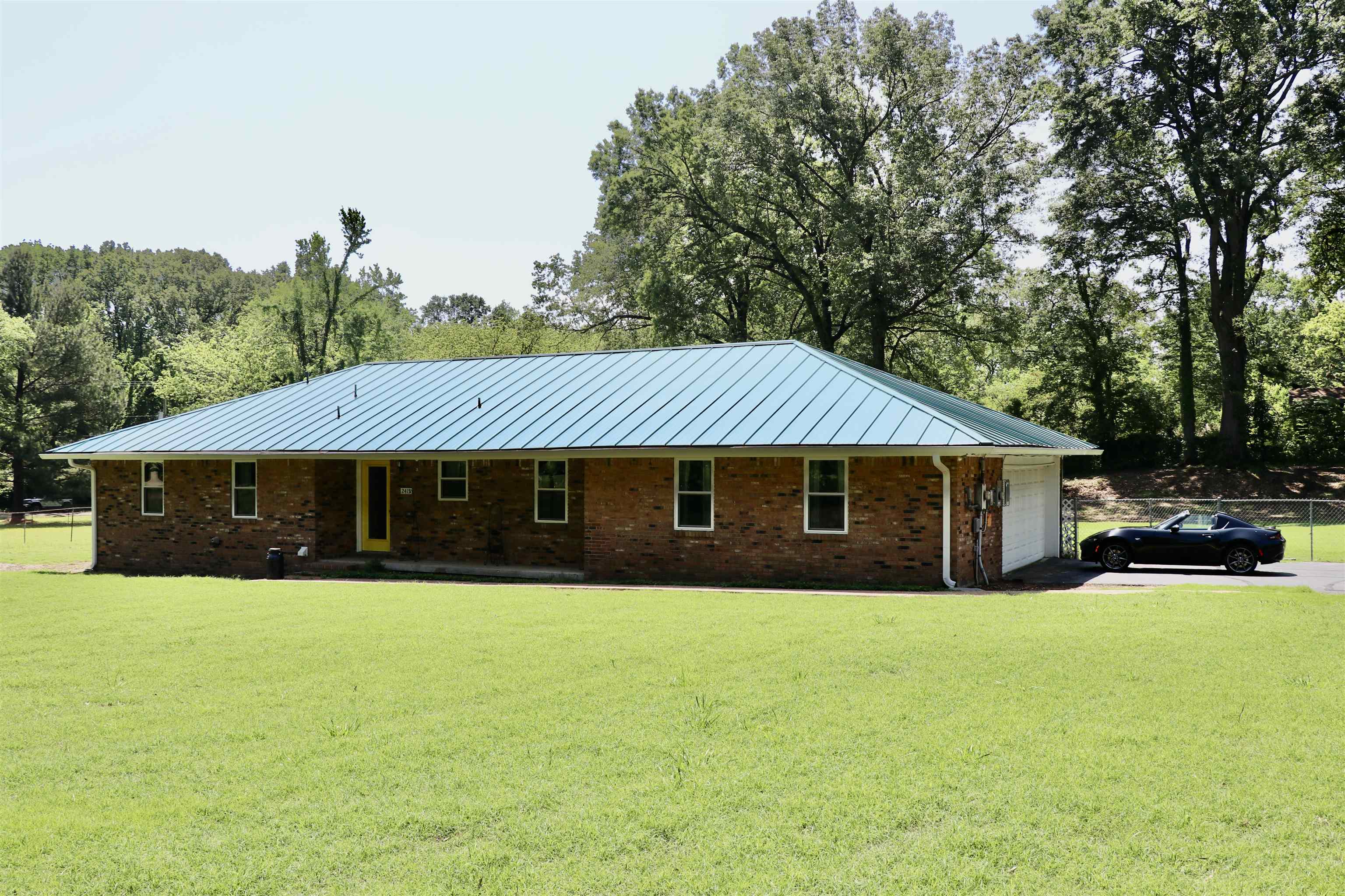 2415 Fite Road Memphis, TN 38127 - Photo 1 of 10 a front view of house with yard and trees all around