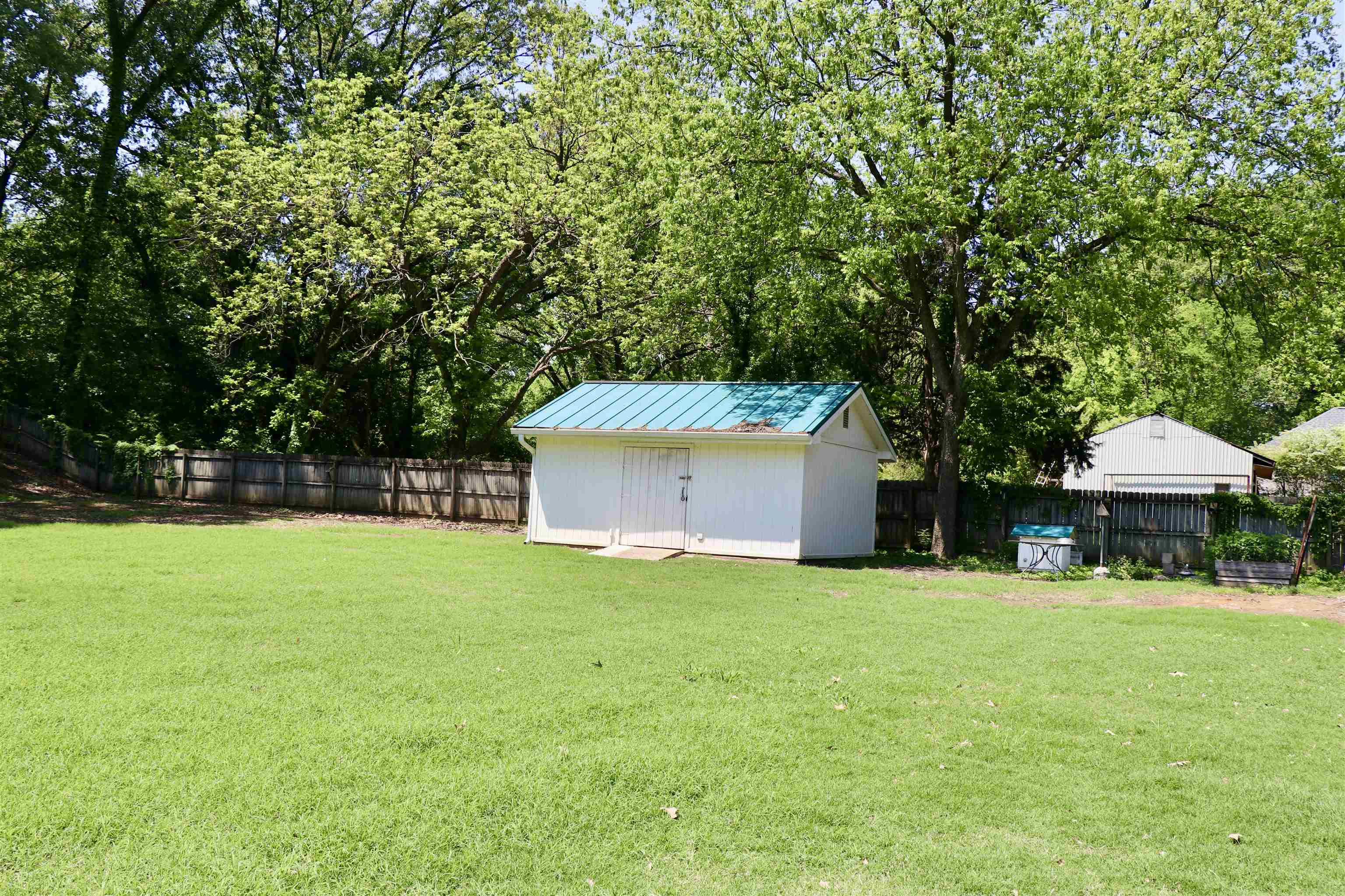 2415 Fite Road Memphis, TN 38127 - Photo 8 of 10 a white house with a big yard and large trees