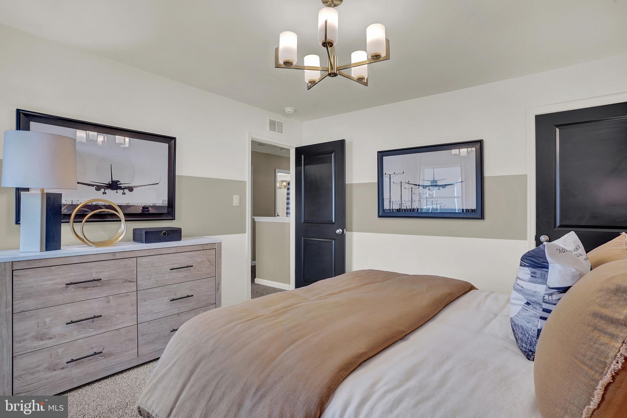 301 Eclipse Street Ranson, WV 25438 - Photo 14 of 26 a bedroom with a bed and a chandelier