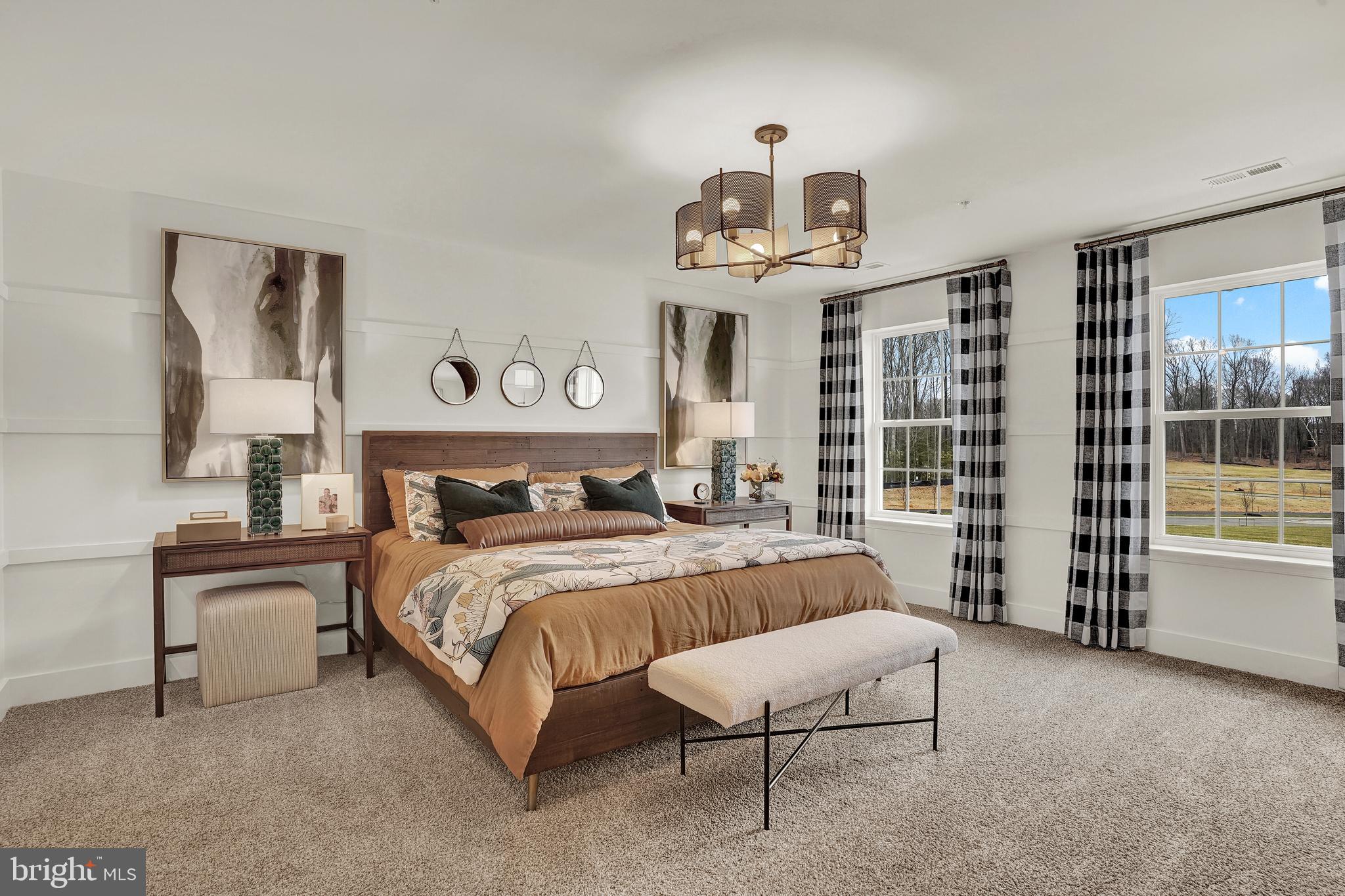 301 Eclipse Street Ranson, WV 25438 - Photo 16 of 26 a bedroom with a large bed and a chandelier