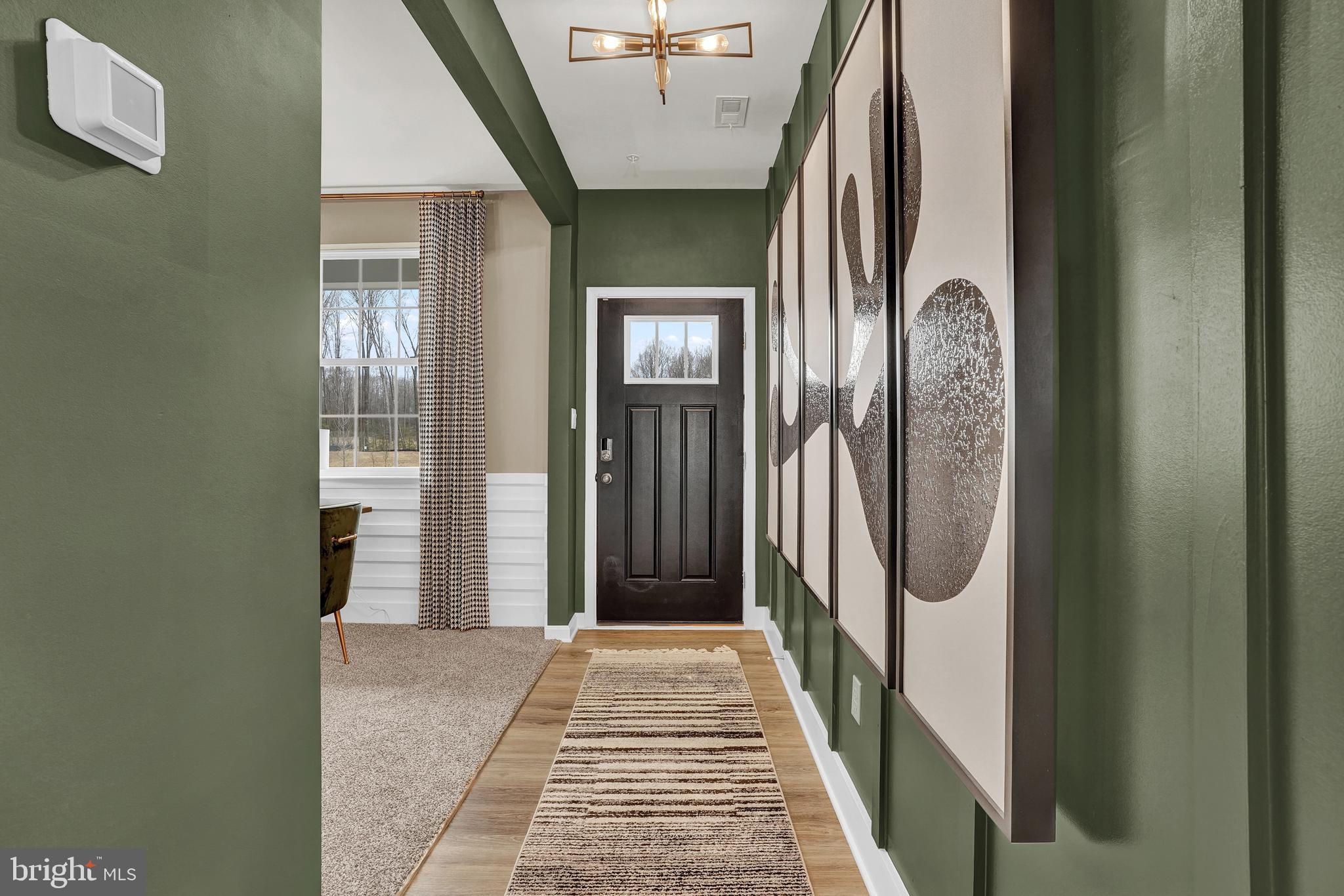 301 Eclipse Street Ranson, WV 25438 - Photo 3 of 26 a view of a hallway with wooden floor and entryway