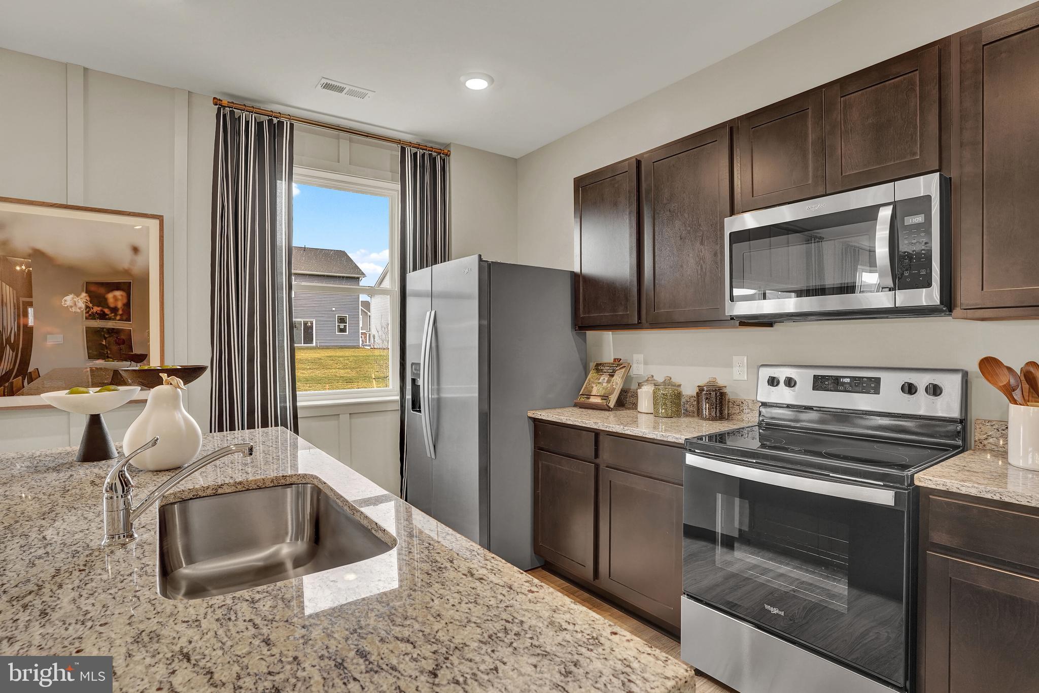 301 Eclipse Street Ranson, WV 25438 - Photo 6 of 26 a kitchen with stainless steel appliances granite countertop a refrigerator stove and sink