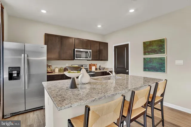 a kitchen with granite countertop a counter space cabinets and stainless steel appliances
