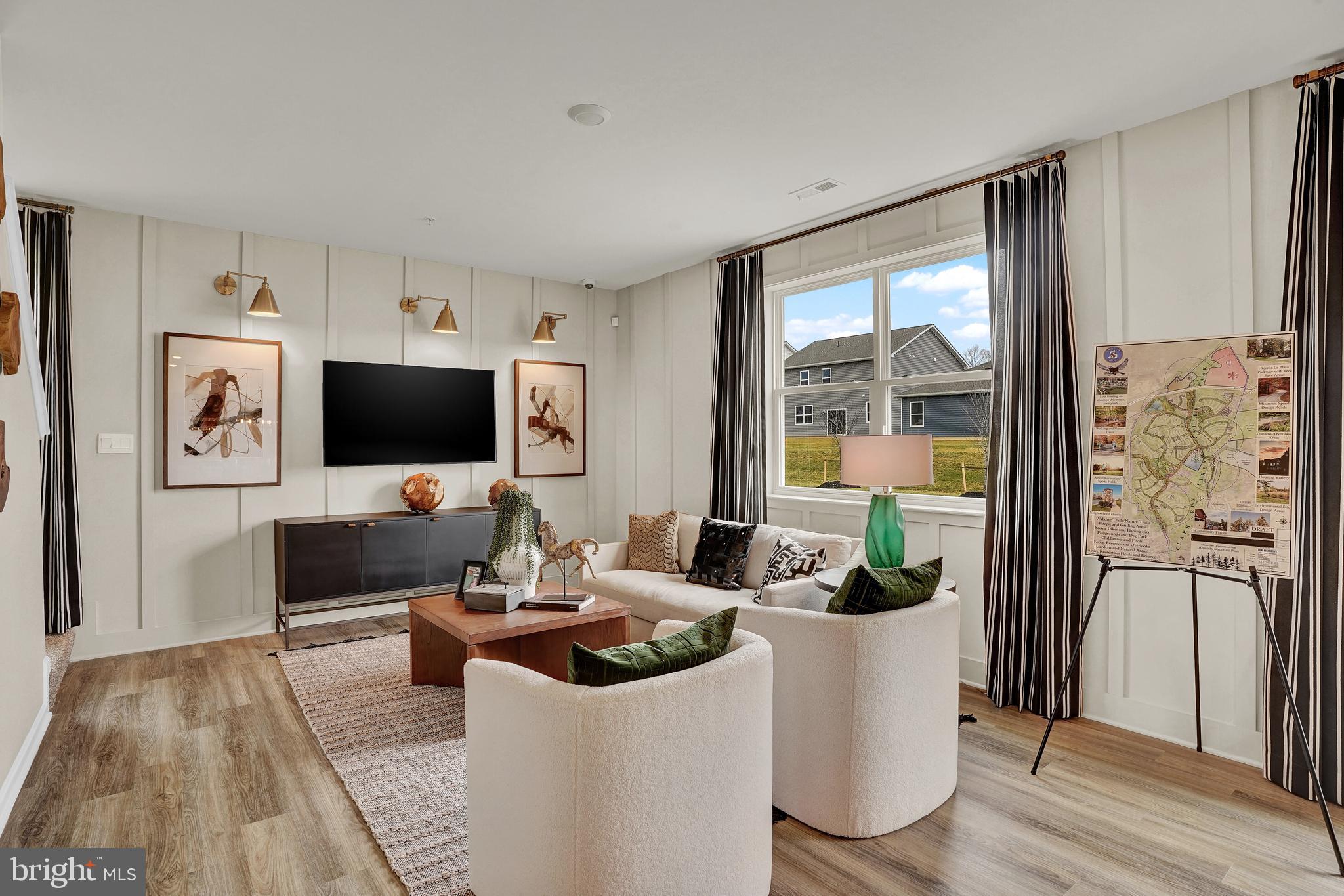 301 Eclipse Street Ranson, WV 25438 - Photo 10 of 26 a work room with furniture a flat screen tv and a floor to ceiling window