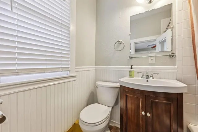 a bathroom with a toilet a sink and a mirror