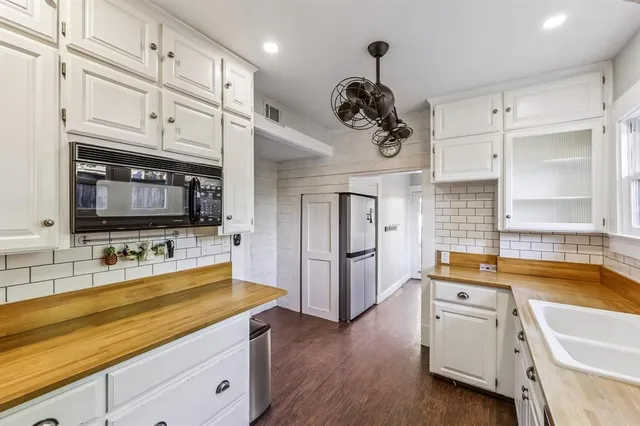 a kitchen with a refrigerator and a sink