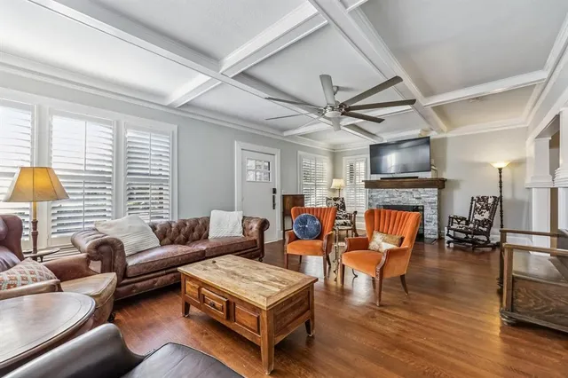 a living room with furniture a fireplace and a large window