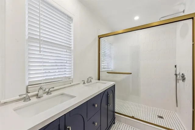 a bathroom with a double vanity sink and a mirror