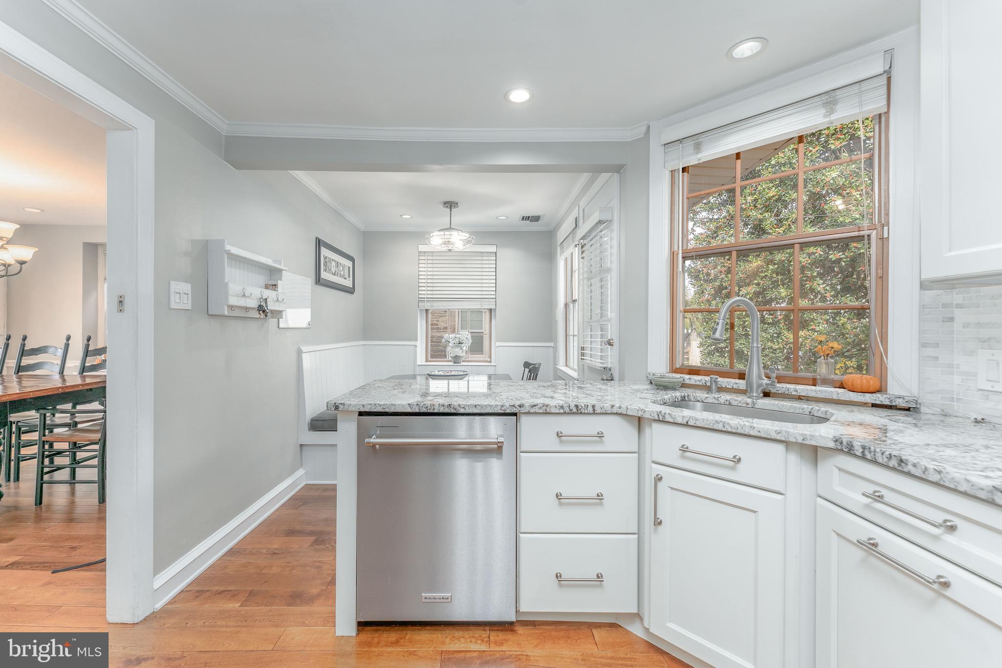 111 Harrogate Road Wynnewood, PA 19096 - Photo 19 of 60 a kitchen with stainless steel appliances granite countertop a stove a sink and white cabinets with wooden floor