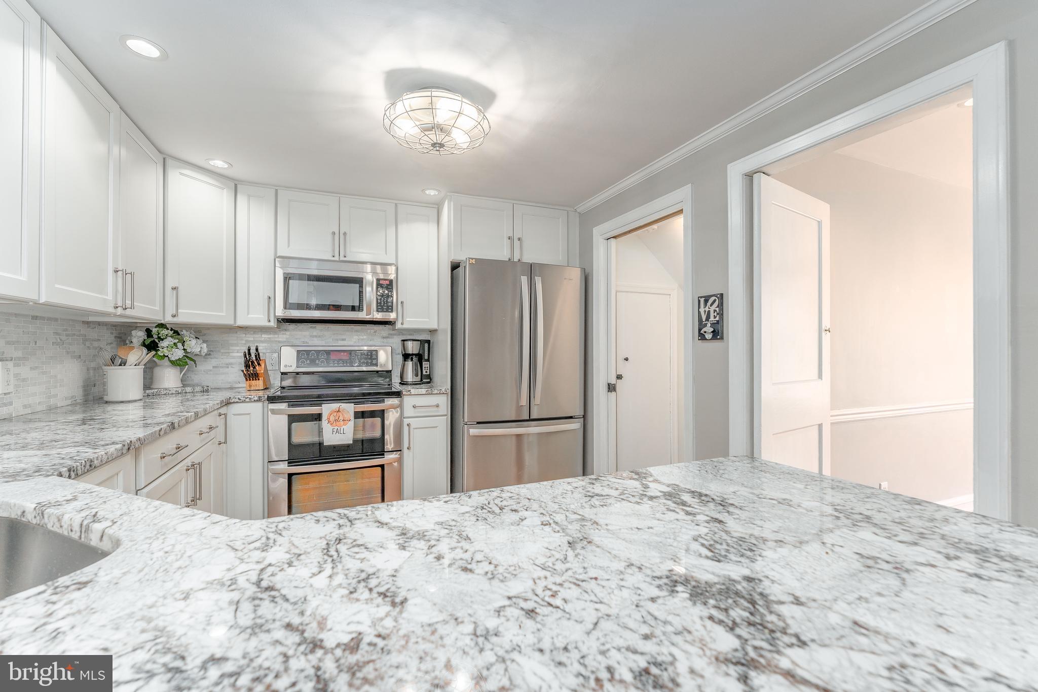 111 Harrogate Road Wynnewood, PA 19096 - Photo 23 of 60 a kitchen with granite countertop a refrigerator and a sink