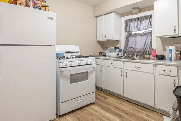 a kitchen with cabinets appliances a sink and a counter