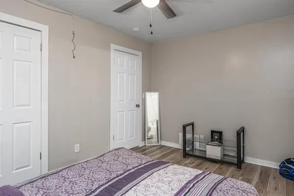 a spacious bedroom with a bed and a chandelier