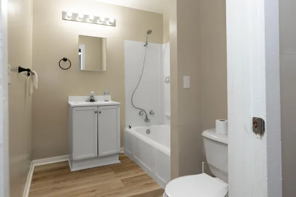 a bathroom with a sink a toilet and shower