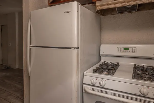a white refrigerator freezer sitting inside of a kitchen