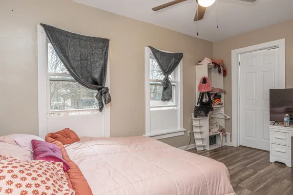 a bedroom with a bed and a flat screen tv