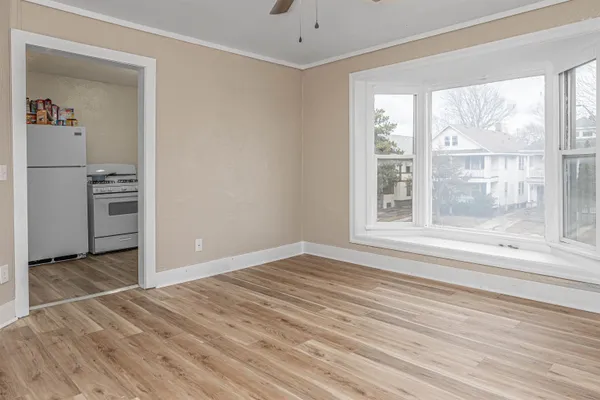 a view of wooden floor and windows in a room