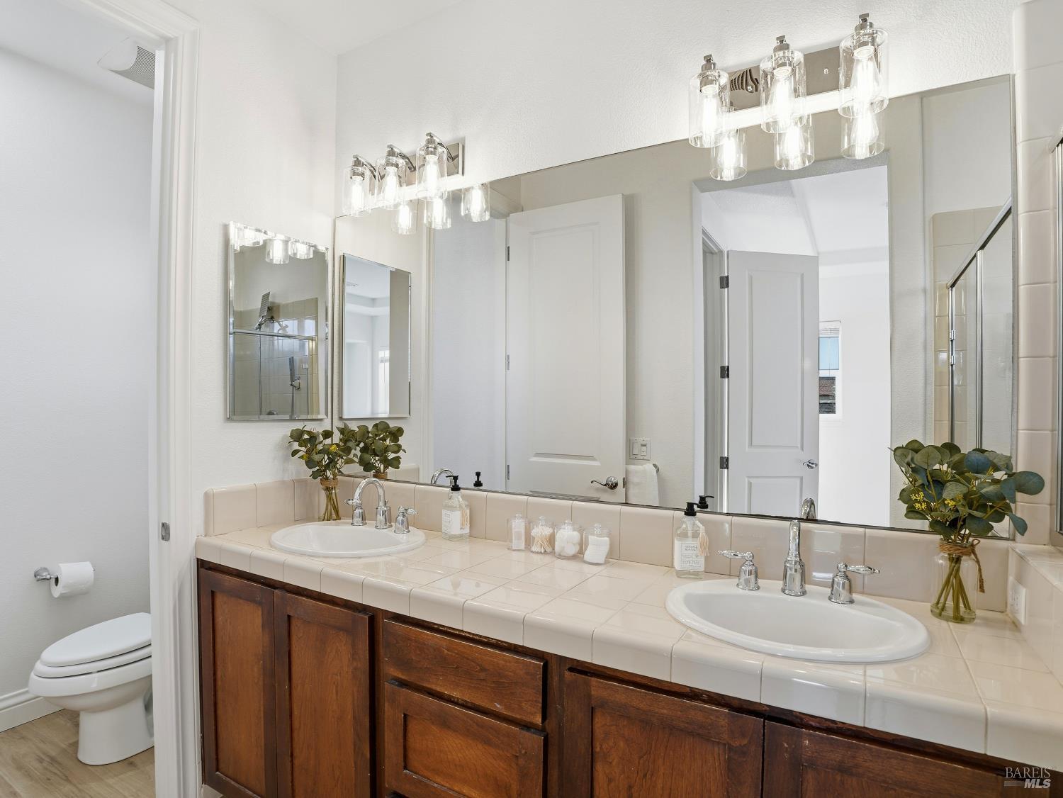 4424 Streamside Drive Santa Rosa, CA 95409 - Photo 36 of 55 a bathroom with a granite countertop sink and a mirror