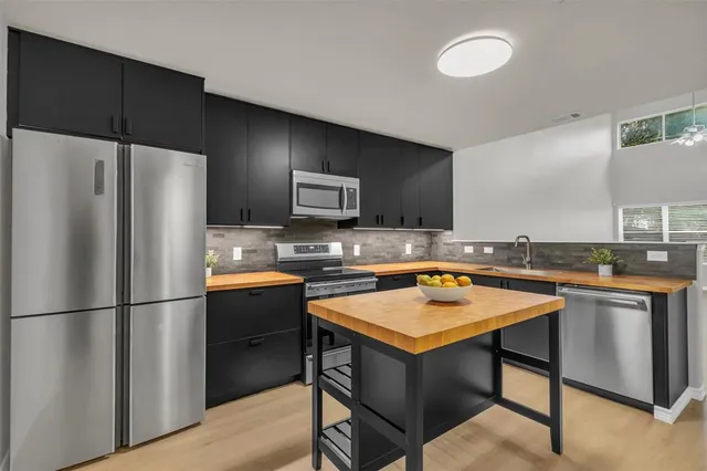 a kitchen with a refrigerator a sink and a stove