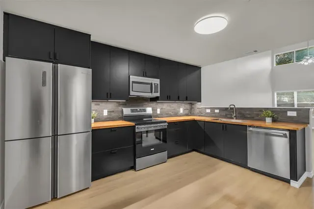 a kitchen with granite countertop a refrigerator and a sink