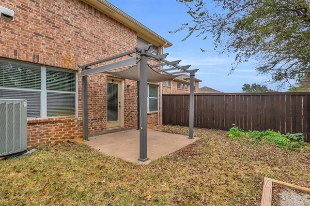 a building with a door and a yard