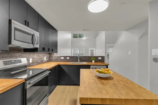 a kitchen with a sink appliances and cabinets
