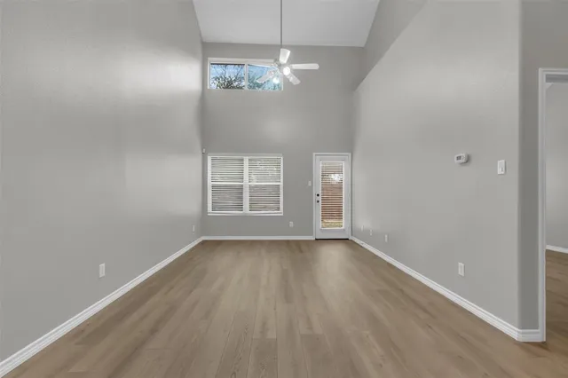 wooden floor in an empty room with a window