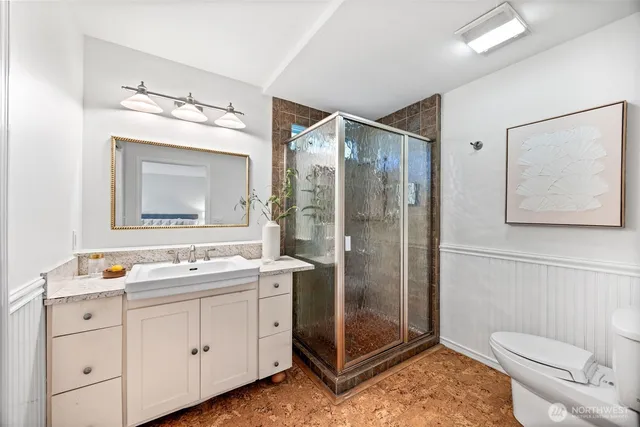a bathroom with a toilet a sink and glass door