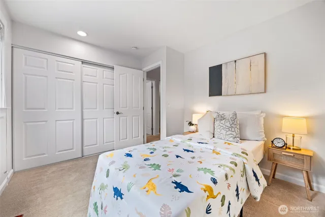 a bedroom with a bed and a painting