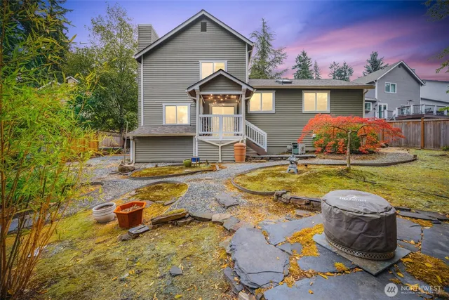 a backyard of a house with table and chairs
