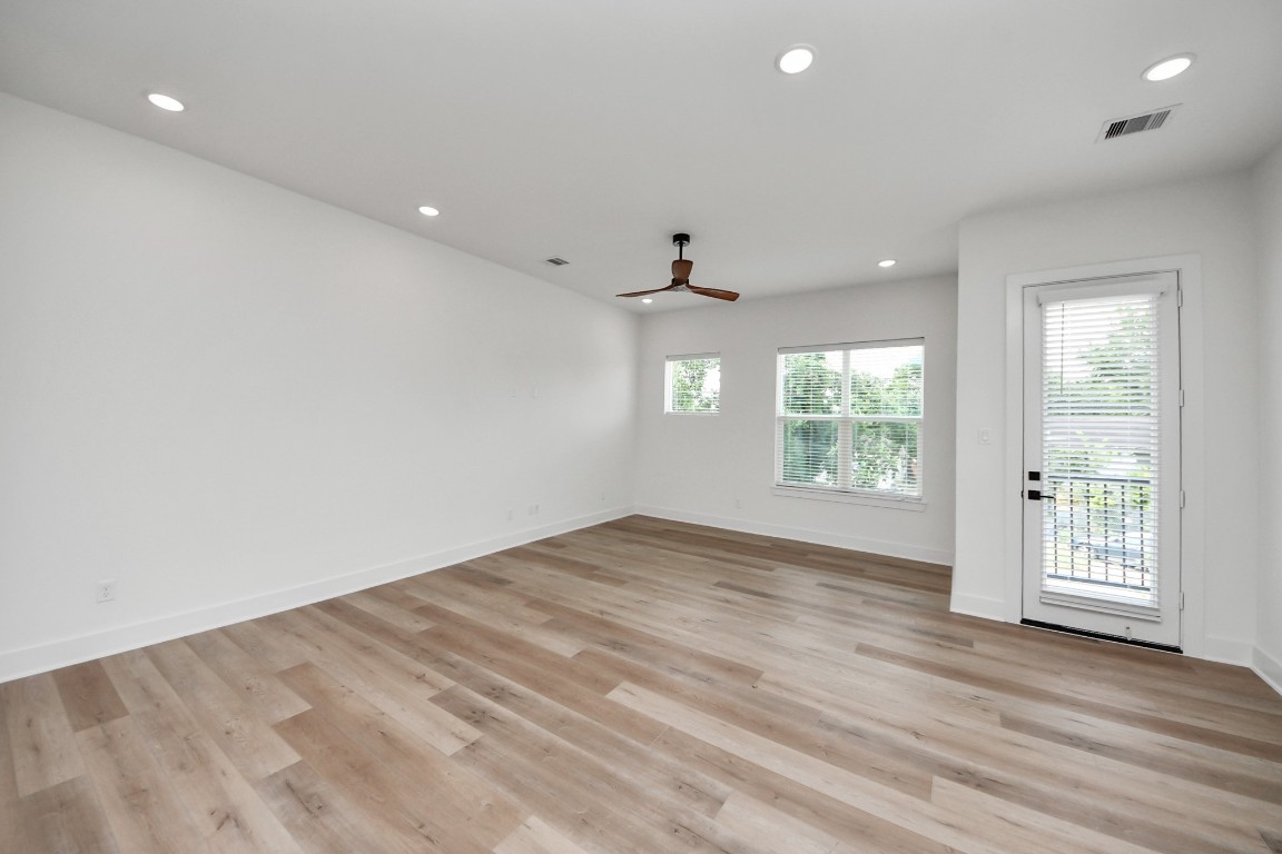 3313 Daphne Street Houston, TX 77021 - Photo 16 of 34 an empty room with wooden floor and windows