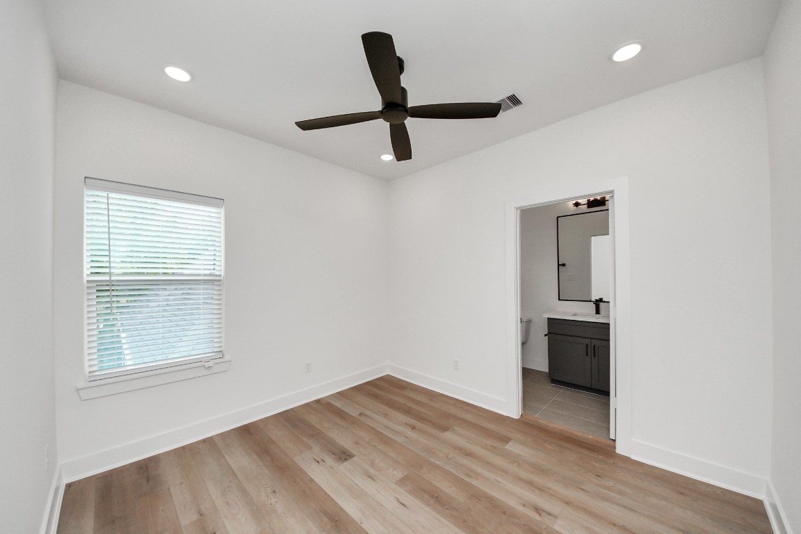 3313 Daphne Street Houston, TX 77021 - Photo 19 of 34 a view of a livingroom with wooden floor and a ceiling fan