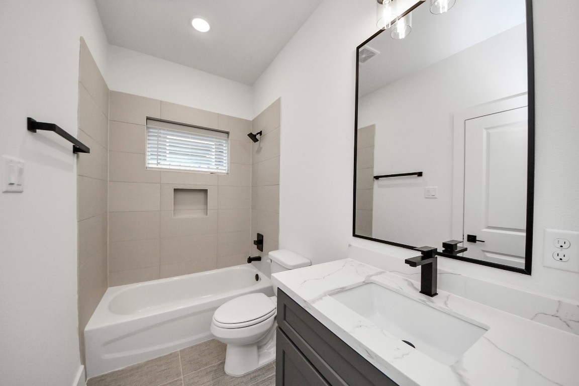 3313 Daphne Street Houston, TX 77021 - Photo 20 of 34 a bathroom with a sink a toilet and a mirror