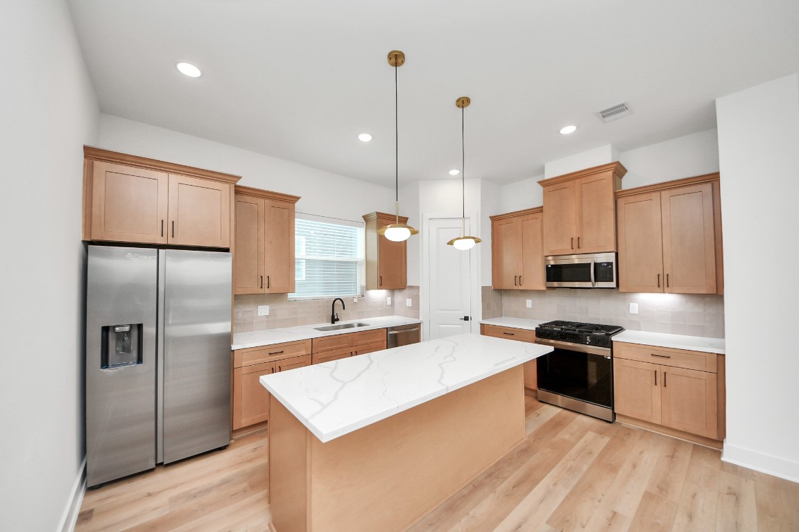 3313 Daphne Street Houston, TX 77021 - Photo 8 of 34 a kitchen with stainless steel appliances granite countertop a refrigerator a stove a sink and a microwave