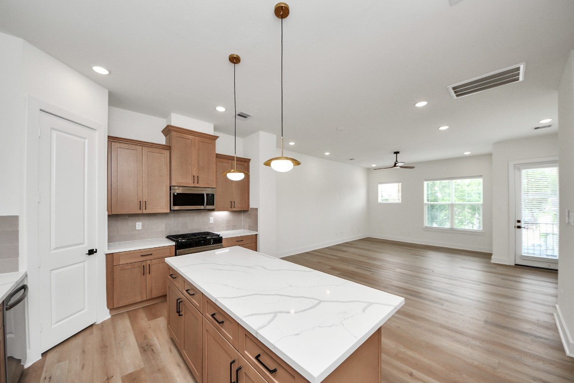 3313 Daphne Street Houston, TX 77021 - Photo 10 of 34 a kitchen with kitchen island a sink stainless steel appliances and cabinets