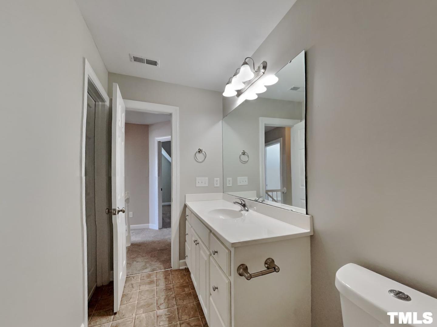 225 Bear Oak Drive Smithfield, NC 27577 - Photo 13 of 17 a spacious bathroom with a double vanity sink and a mirror