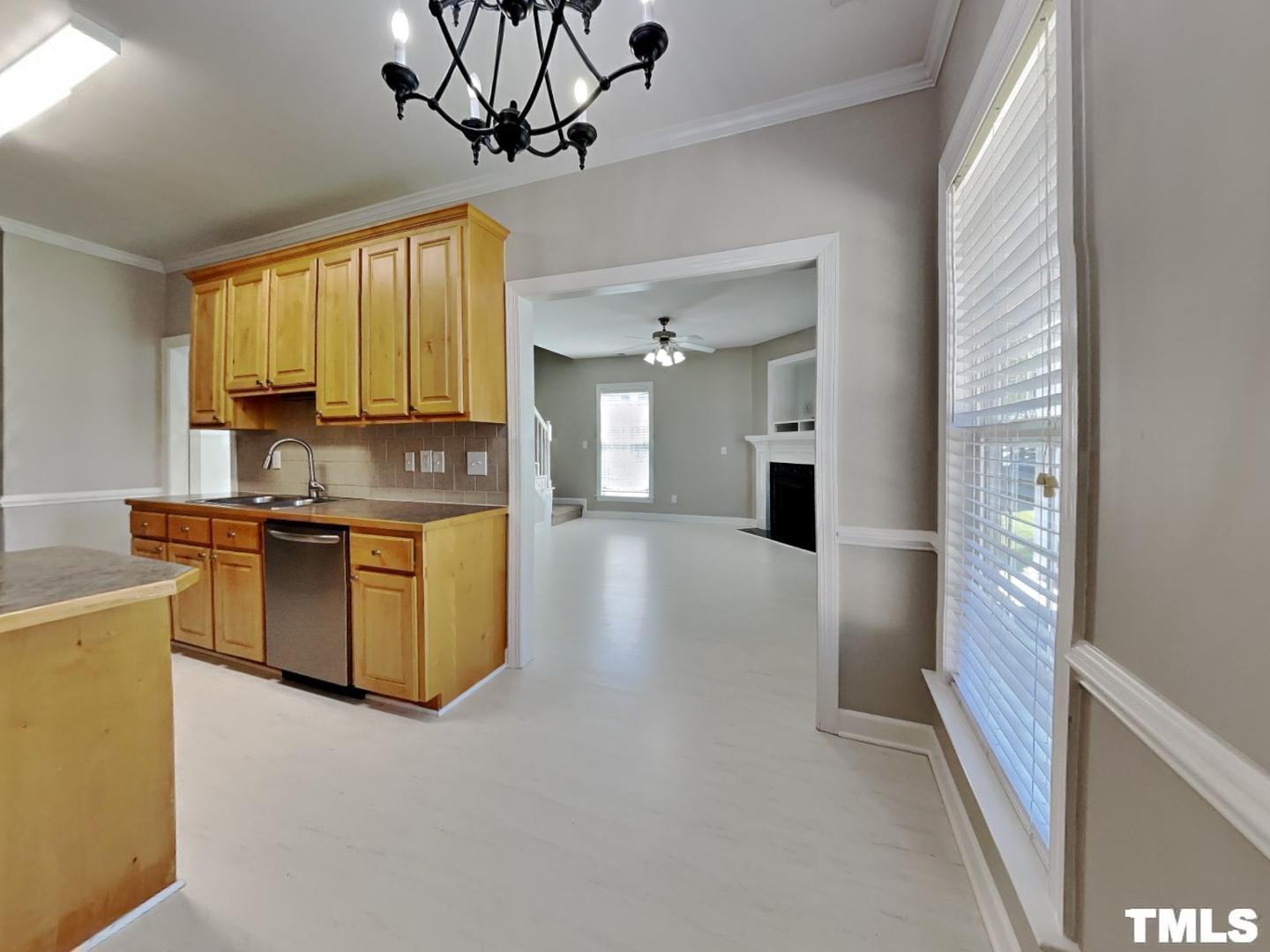 225 Bear Oak Drive Smithfield, NC 27577 - Photo 7 of 17 a kitchen with stainless steel appliances kitchen island granite countertop a refrigerator a stove and a sink with large window
