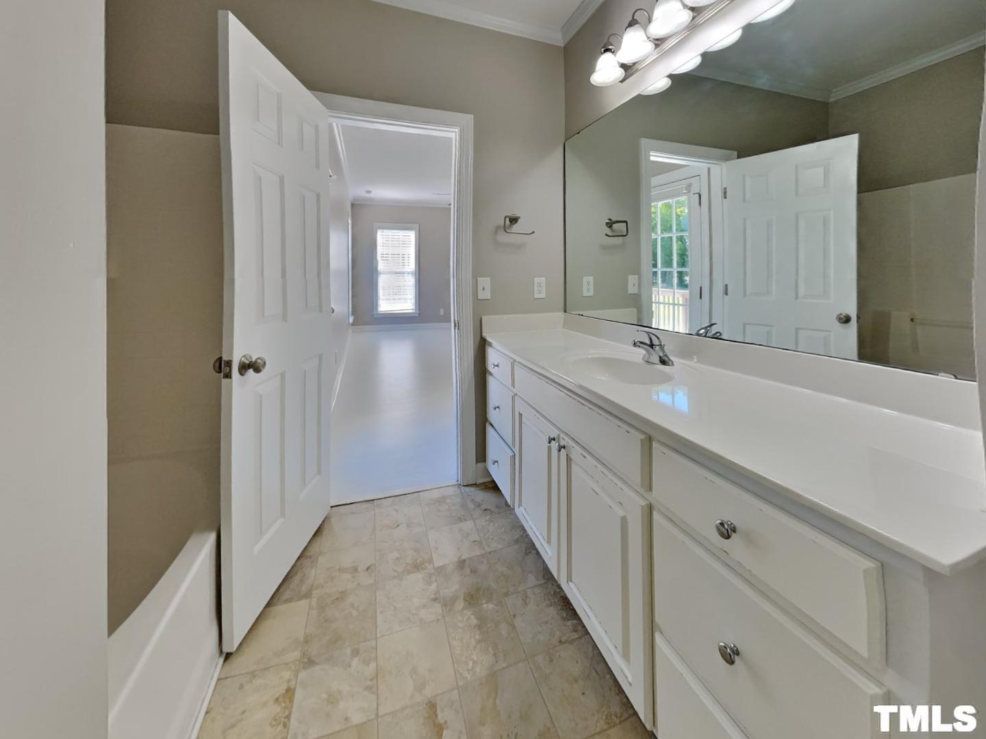 225 Bear Oak Drive Smithfield, NC 27577 - Photo 9 of 17 a bathroom with a double vanity sink and mirror