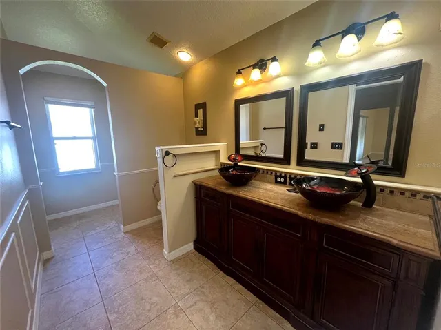 a bathroom with a sink double vanity and a mirror