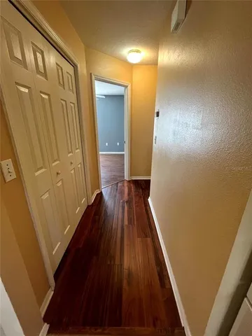 a view of a hallway with wooden floor